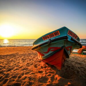 Fishing boat on Negombo beach at sunset
