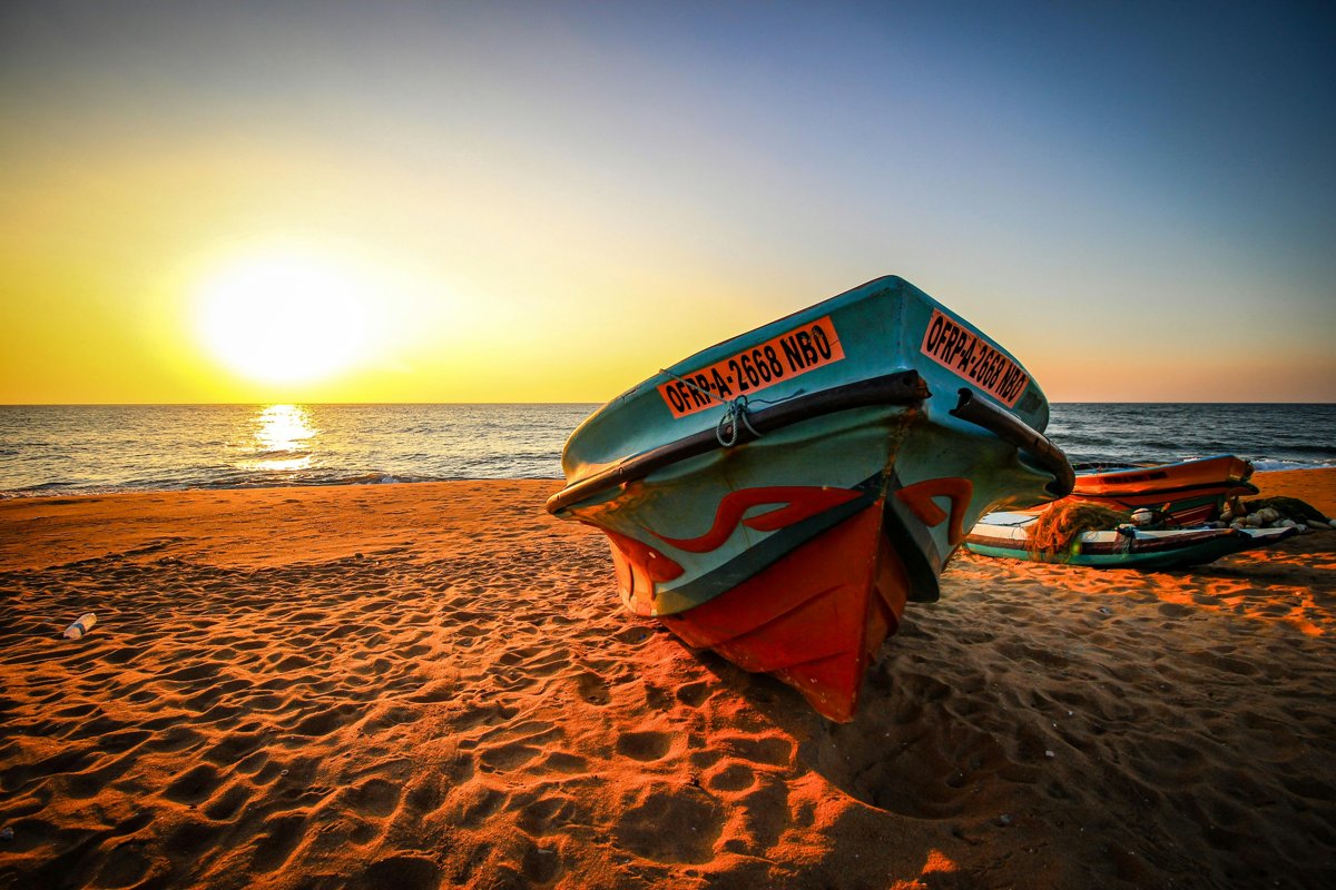 Fishing boat on Negombo beach at sunset