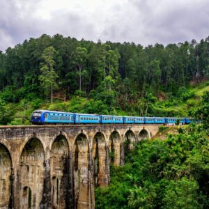 Blue train crossing the Nine Arch Bridge in Ella